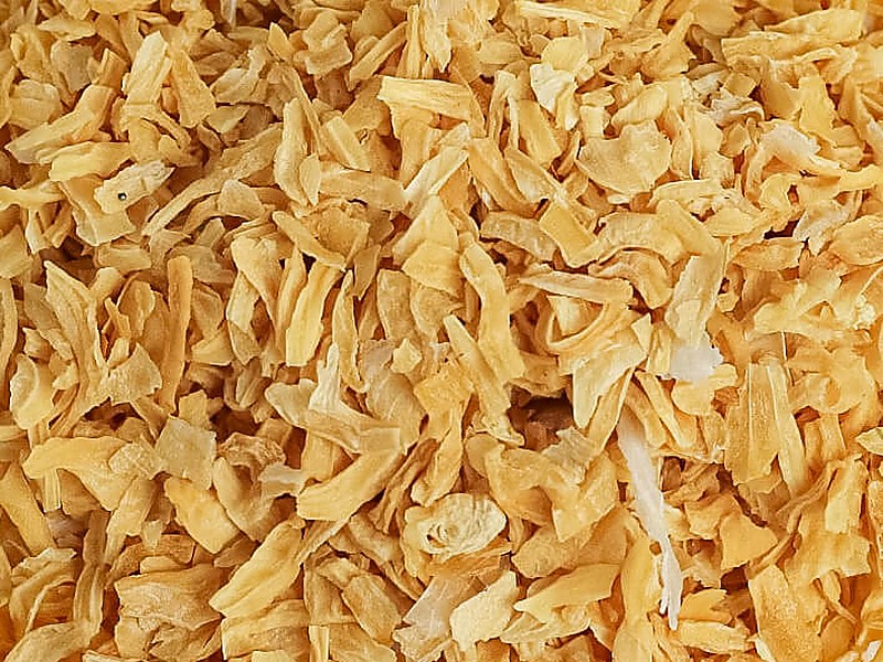 Close-up of dehydrated yellow onion flakes